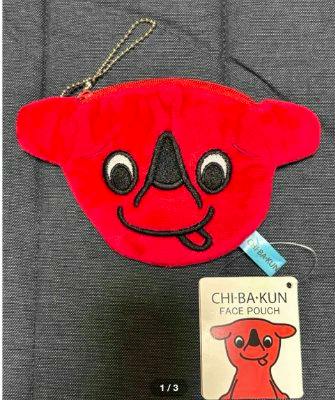 Red Chi-ba-kun face pouch (polyester) with a zipper, small chain, and attached product tag.