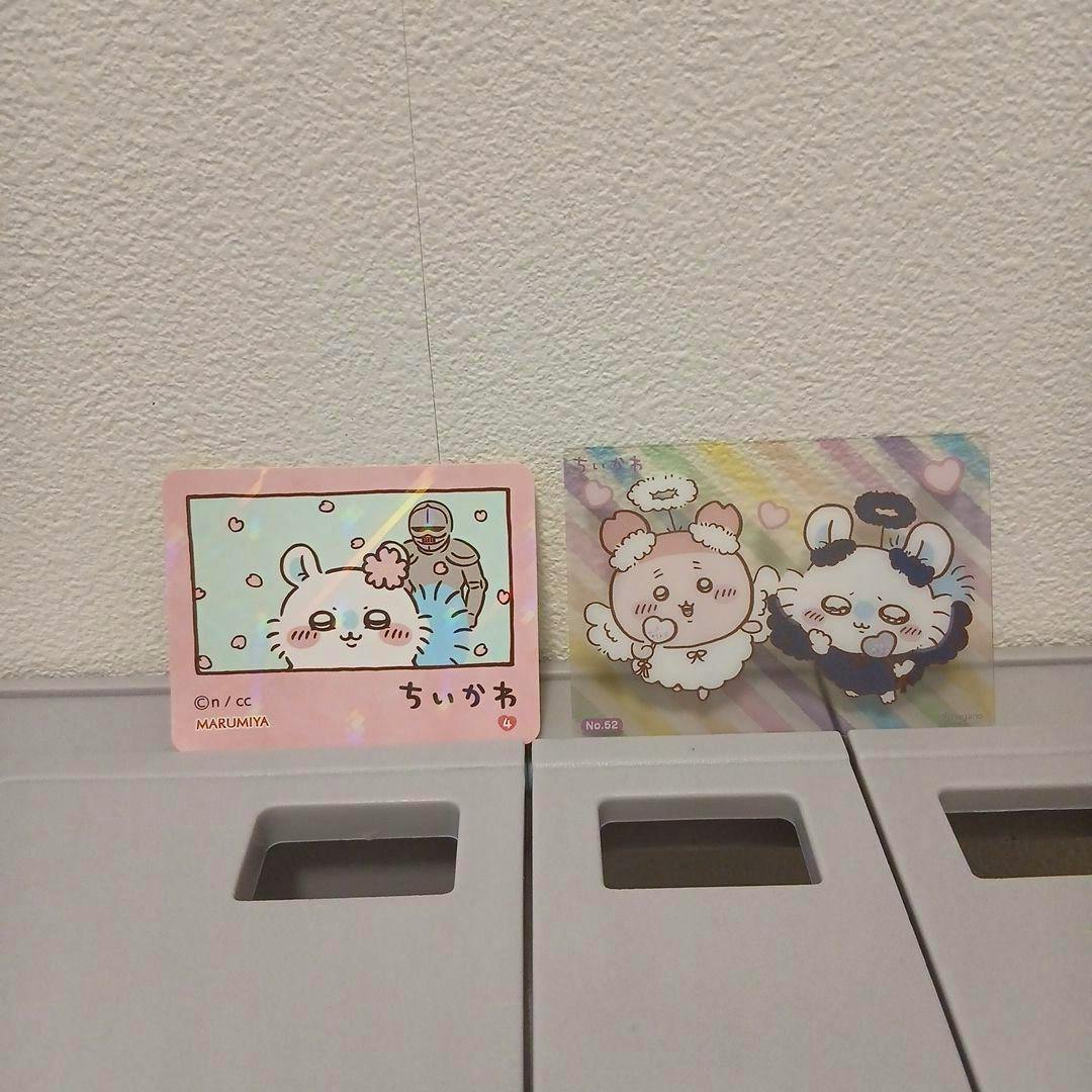 Two ちいかわ sticker cards with pastel character illustrations placed side by side against a textured wall.