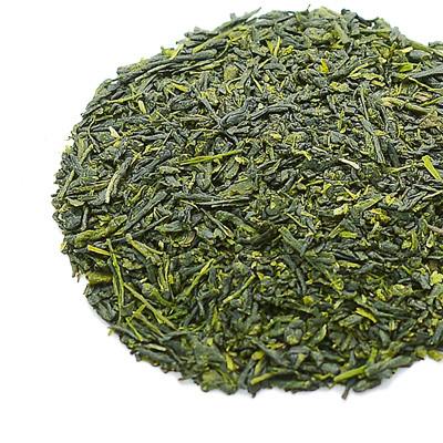 Close-up of loose green tea leaves arranged on a white background.