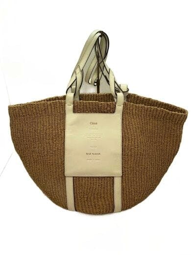 Woven beige Chloe tote bag with a leather front panel and double handles on a white background.