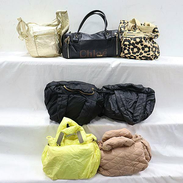 Seven assorted bags from a Chloe bag set displayed on a white stepped surface.