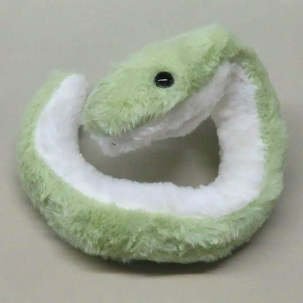 A small green plush snake mascot coiled with a white underside and a black bead eye visible.