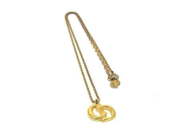 Gold-tone Christian Dior CD logo pendant necklace photographed on a white background.