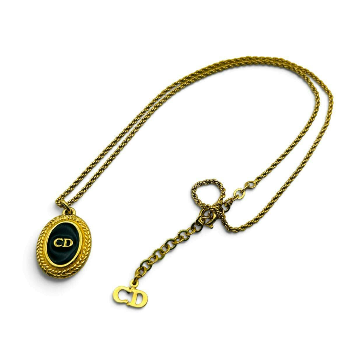 Christian Dior gold and black oval necklace pendant with CD logo on a gold chain and a small CD charm on the extender.