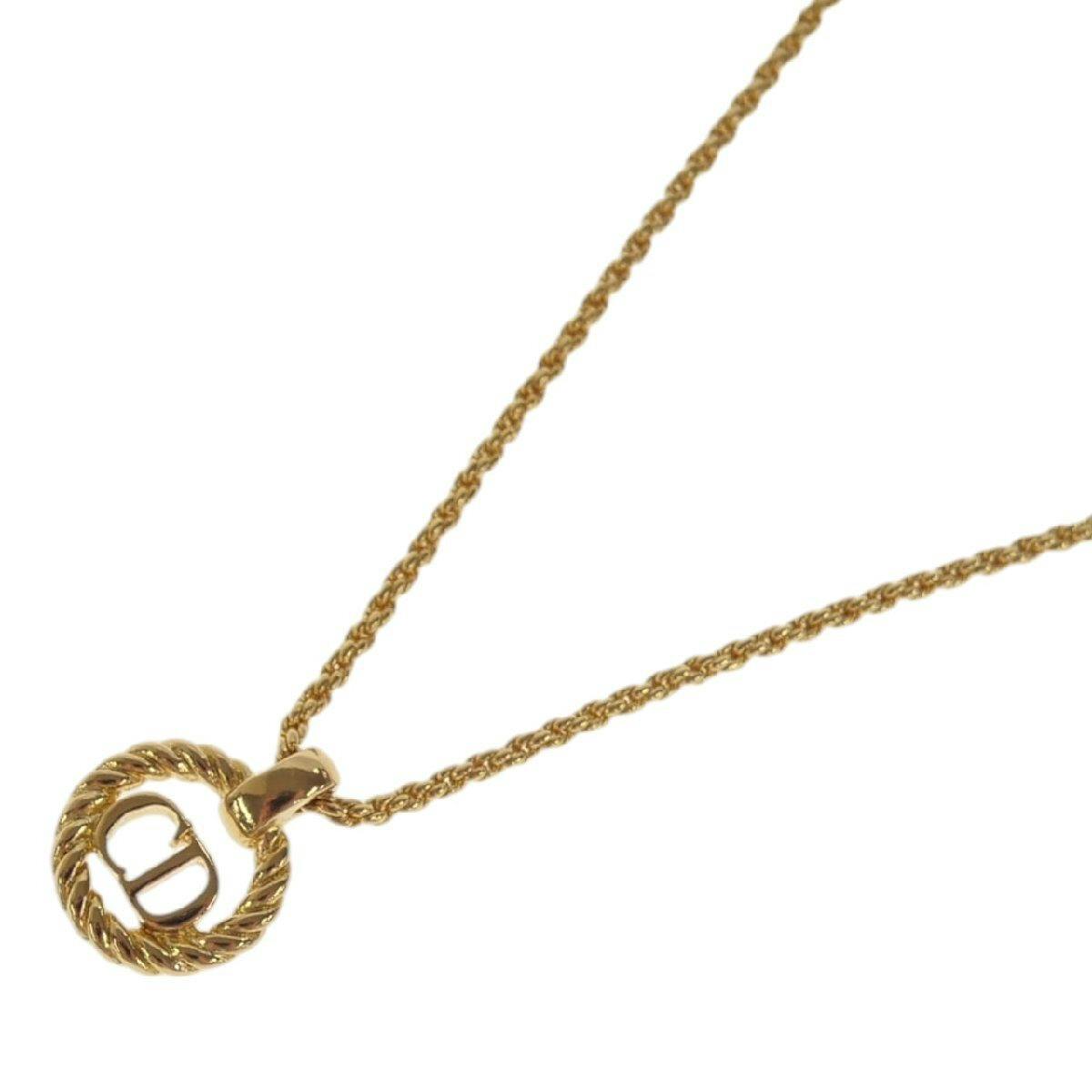 Gold-colored CD logo pendant necklace photographed on a white background.