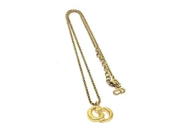 Gold-tone Christian Dior necklace with interlocking CD logo pendant and chain on a white background.