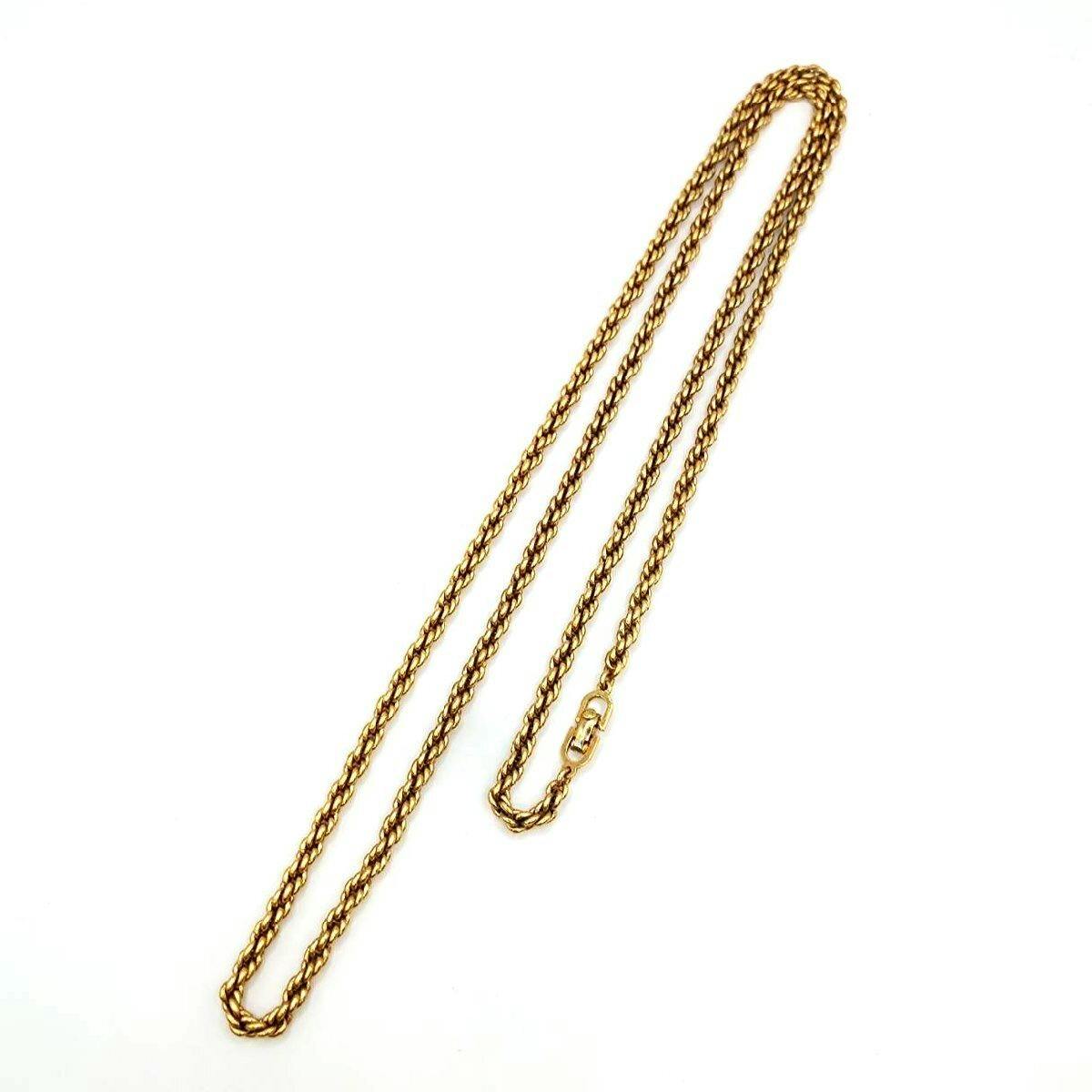 Gold-tone rope chain necklace laid flat on a white background.