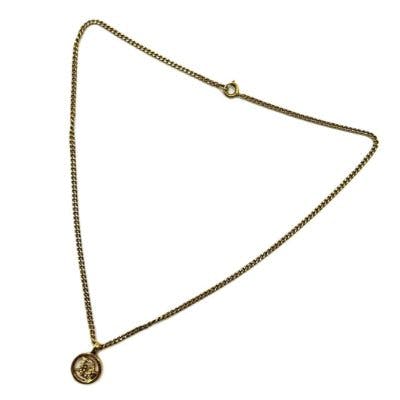 Gold-plated Christian Dior chain necklace with a circular Dior logo pendant on a white background.