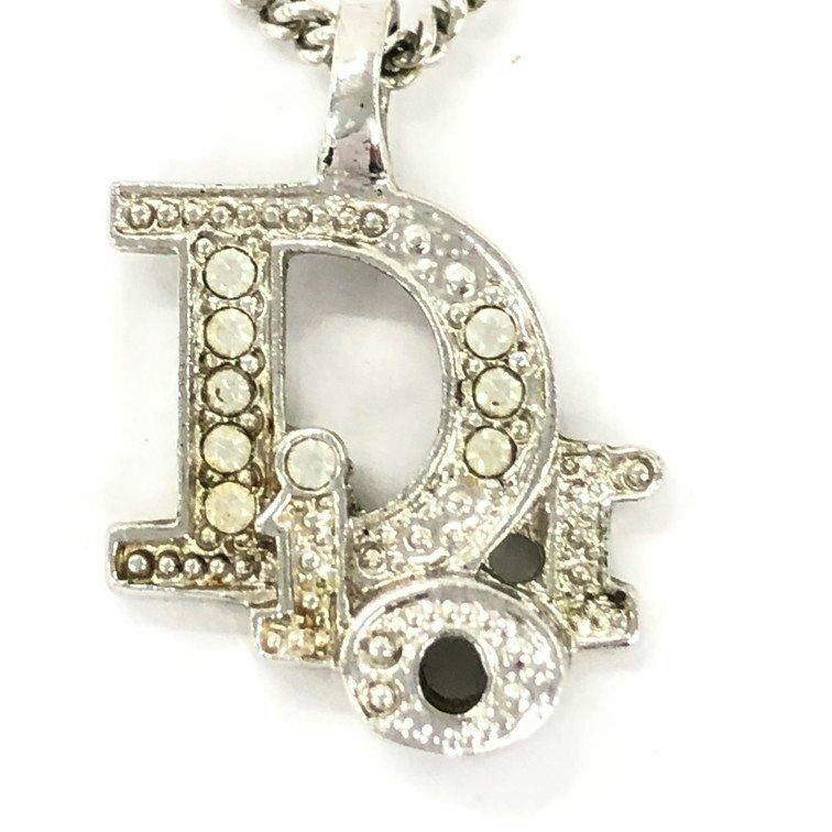 Close-up front view of a silver-tone Dior CD logo pendant with rhinestone accents.