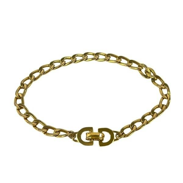 Gold-tone chain bracelet with an interlocking double-link clasp shown on a white background.