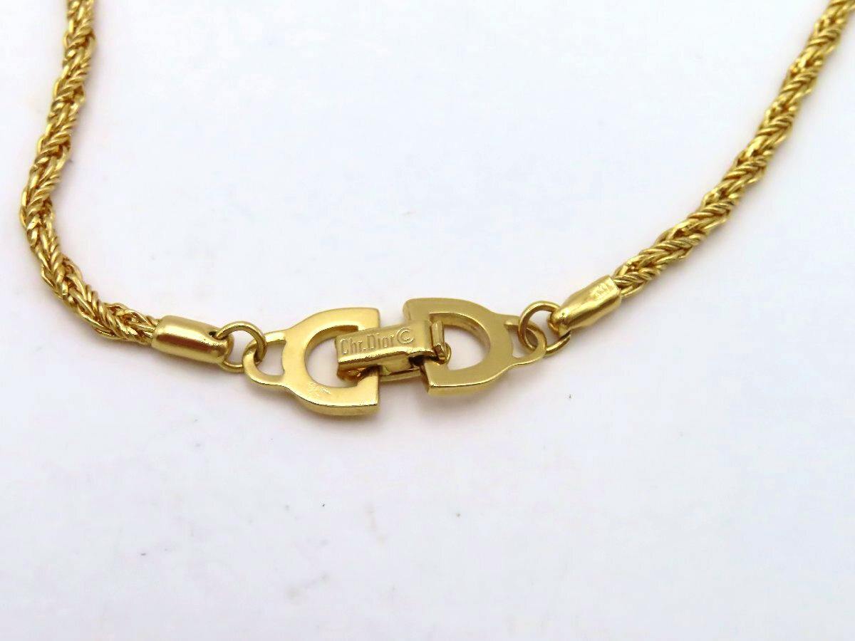 Close-up of a gold-tone Christian Dior necklace clasp and rope-style chain.
