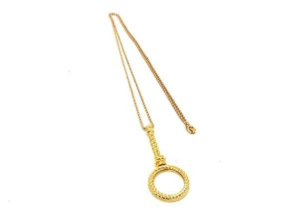Gold-tone Christian Dior necklace with a circular rope-textured pendant displayed on a white background.