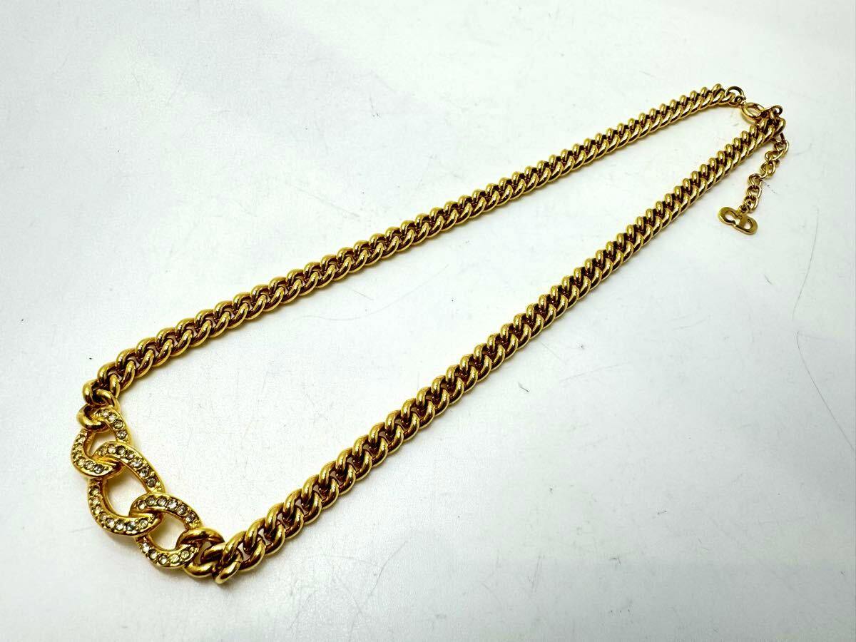 Gold Christian Dior GP rhinestone curb-chain necklace laid flat on a white background.