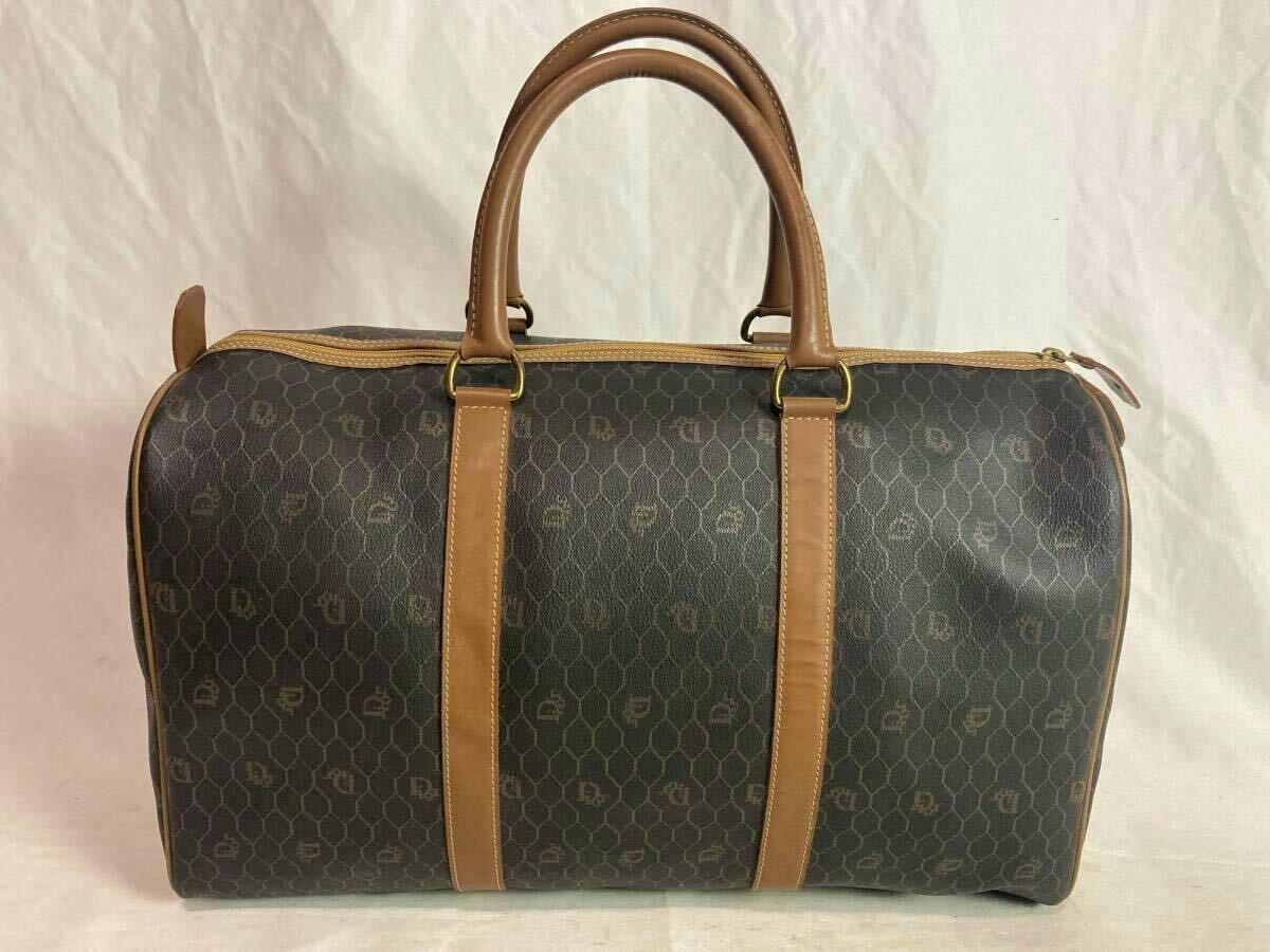 Front view of a brown Christian Dior honeycomb-patterned Boston bag with tan leather handles and trim.