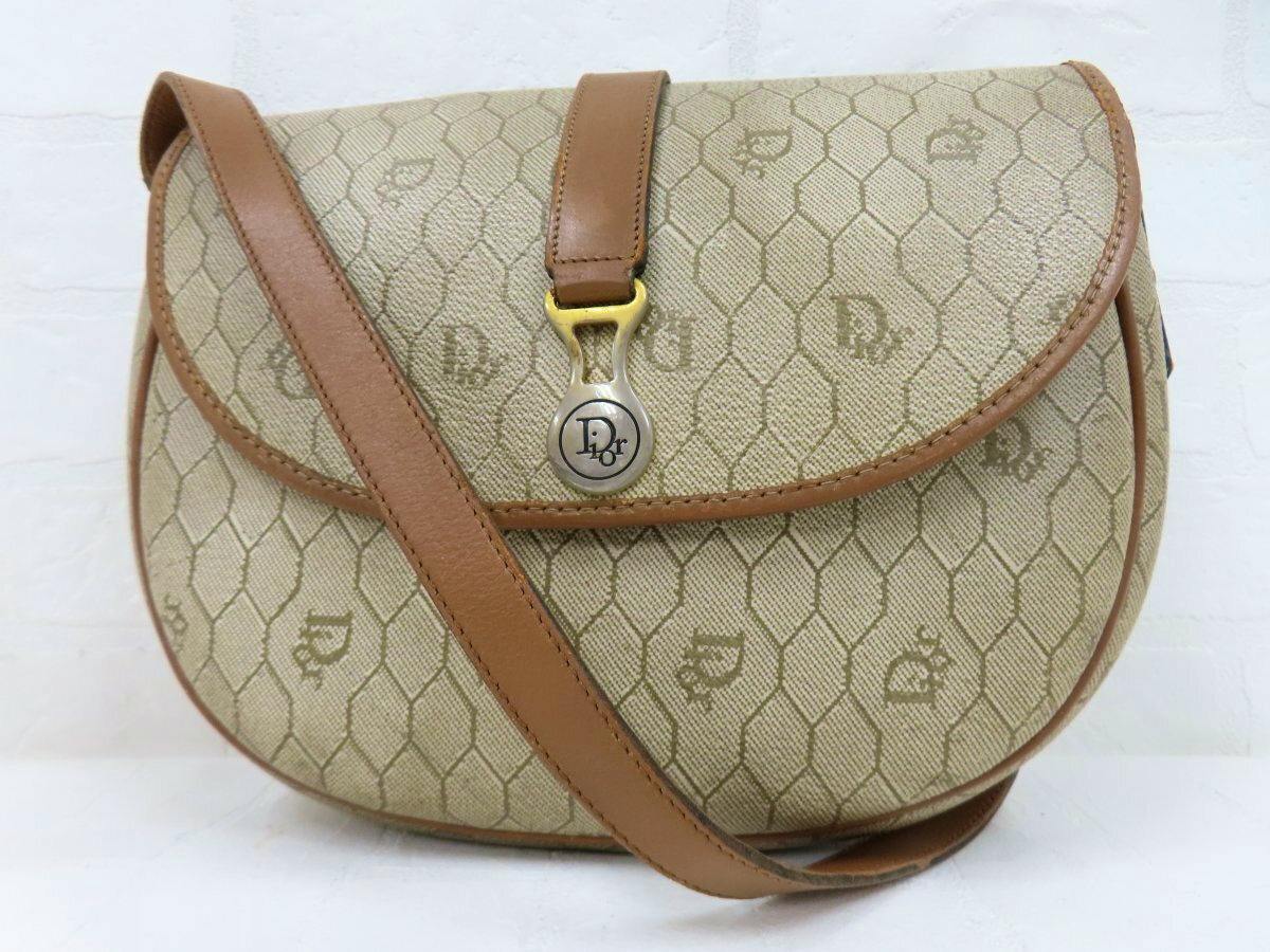 Front view of a Christian Dior brown honeycomb-patterned PVC and calf leather shoulder bag with flap and metal clasp.