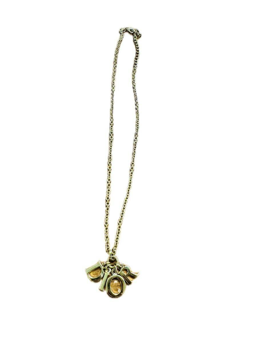 Gold Christian Dior logo necklace with a chain and DIOR letter charms displayed full-length on a white background.