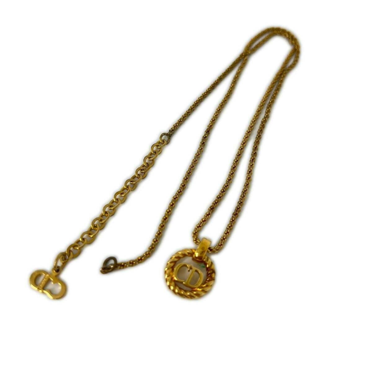 Gold-tone Christian Dior logo twist-circle necklace with pendant and chain displayed on a white background.