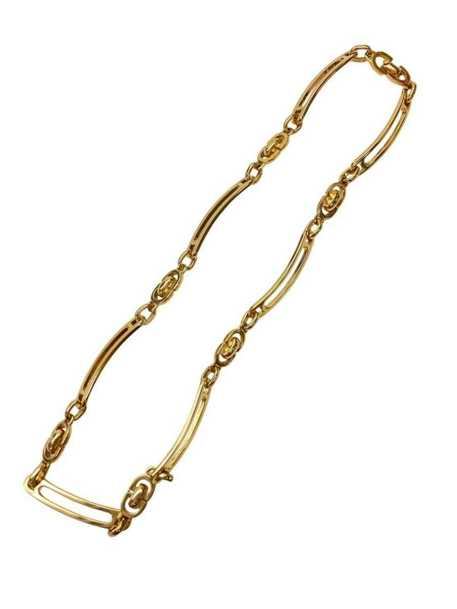 Gold-colored Christian Dior chain necklace with alternating long and short links laid flat on a white background.