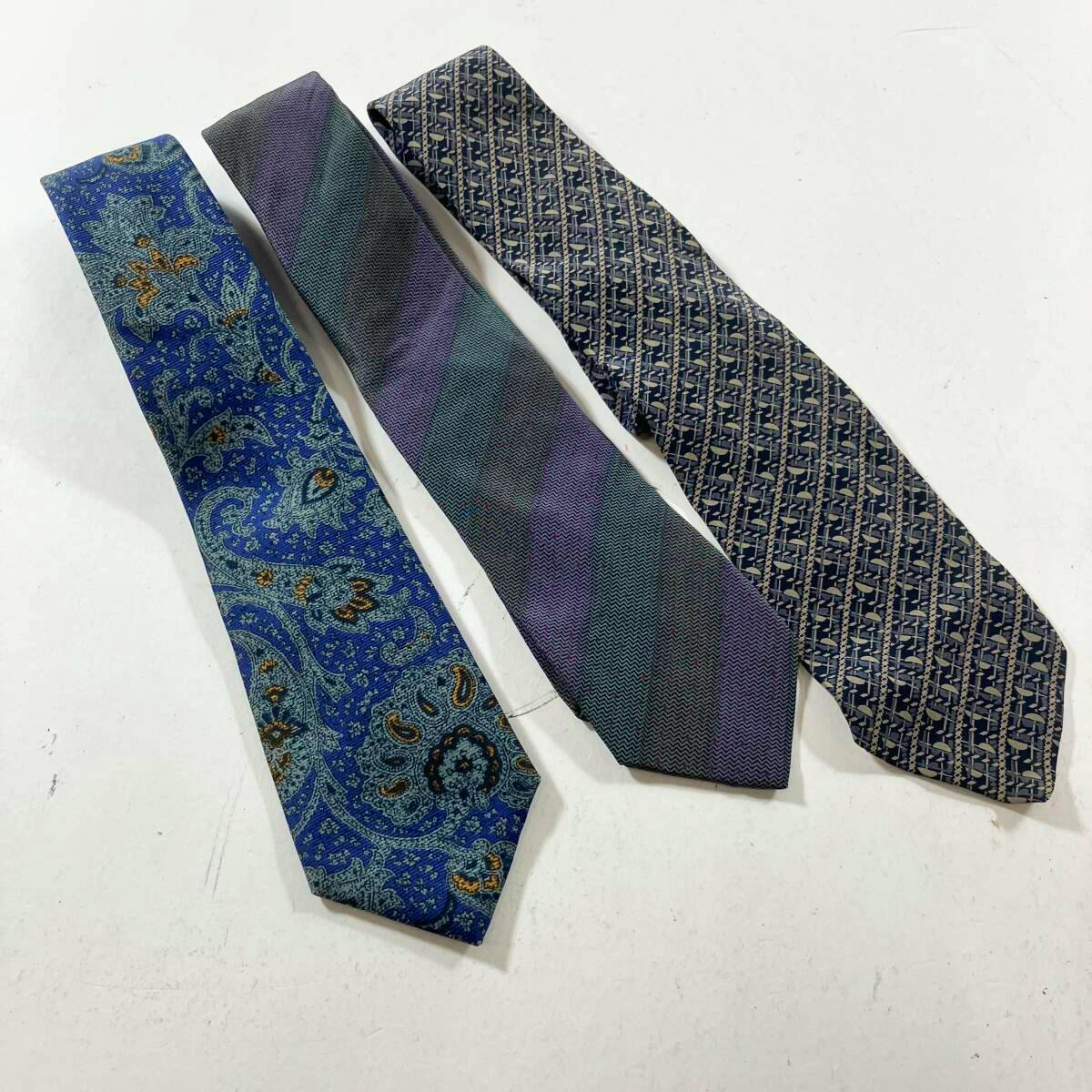 Three neckties laid flat on a white background showing different patterned designs.