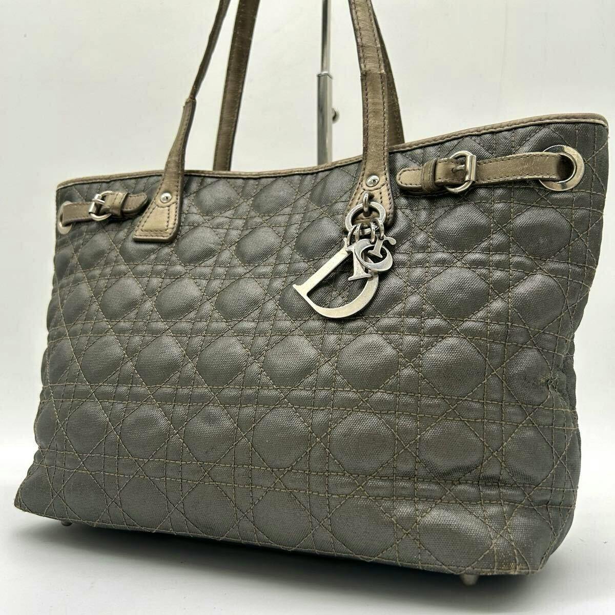 Gray Christian Dior quilted (cannage) tote bag with leather handles and metal Dior letter charm visible.