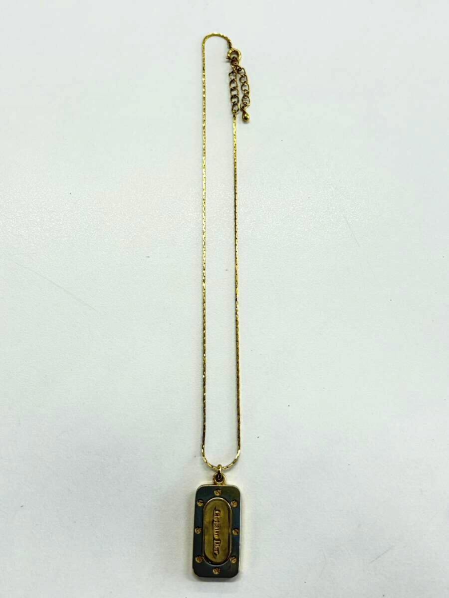 Christian Dior gold-tone necklace with a rectangular pendant on a thin chain, shown on a white background.