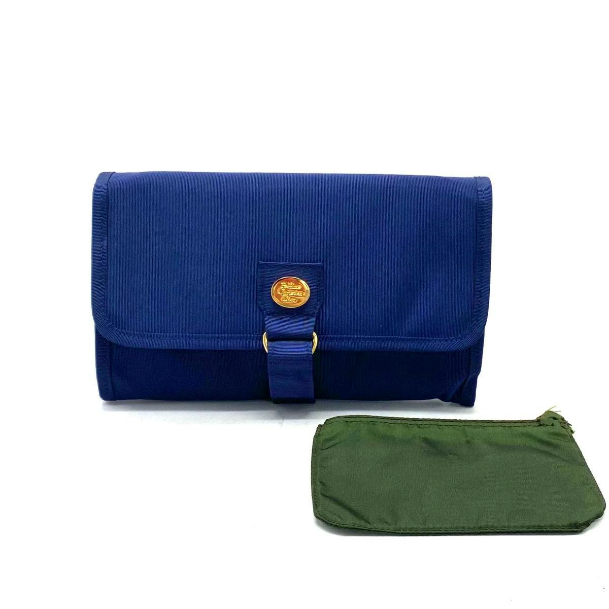 Front view of a blue canvas pouch with a small green zip pouch placed beside it on a white background.