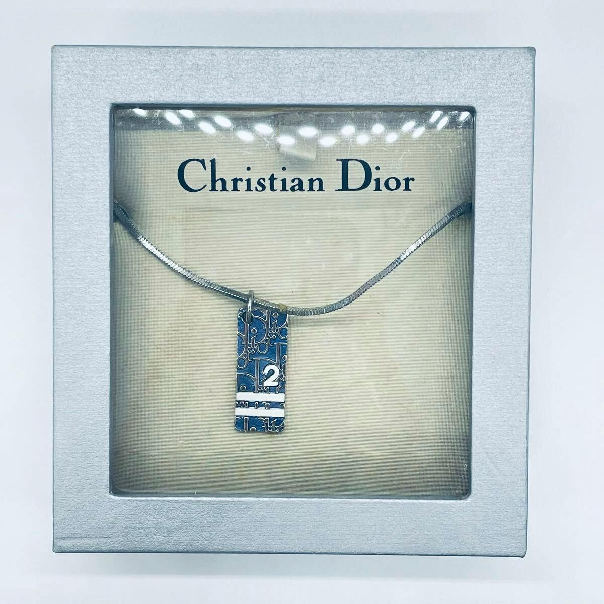 Boxed Christian Dior necklace with a blue rectangular plate pendant marked with the number 2 on a silver-tone chain.