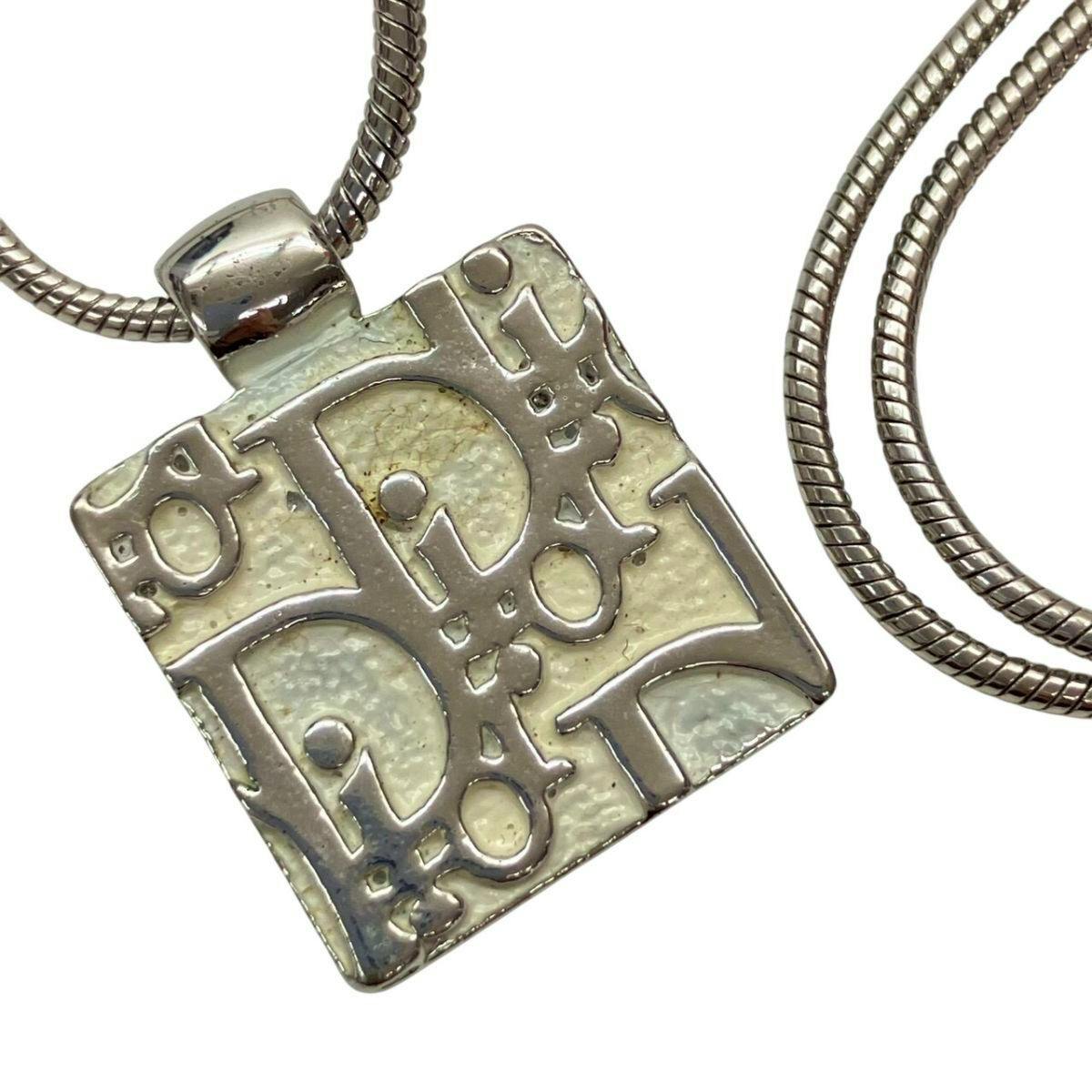 Close-up of the Christian Dior silver-color Trottter plate square pendant necklace showing the pendant and part of the chain.