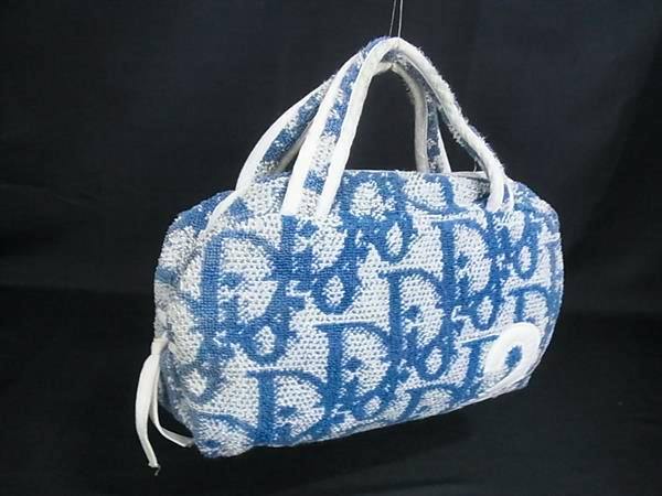Blue and white Christian Dior mini handbag in trotter terry-pile canvas showing the Dior monogram pattern against a black background.