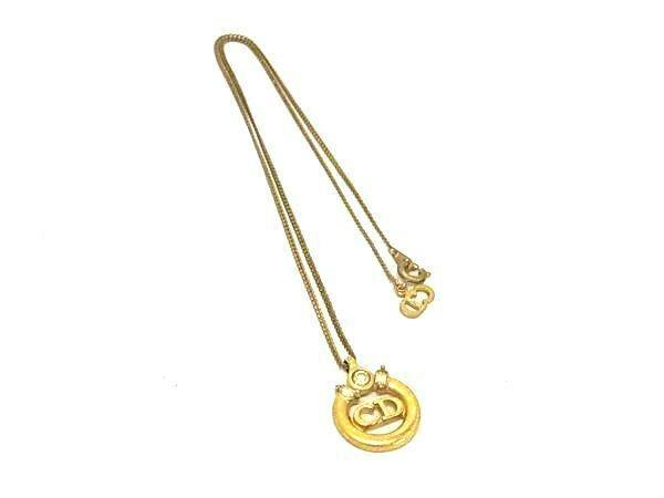 Gold-tone Christian Dior necklace with a round CD logo pendant shown on a white background.