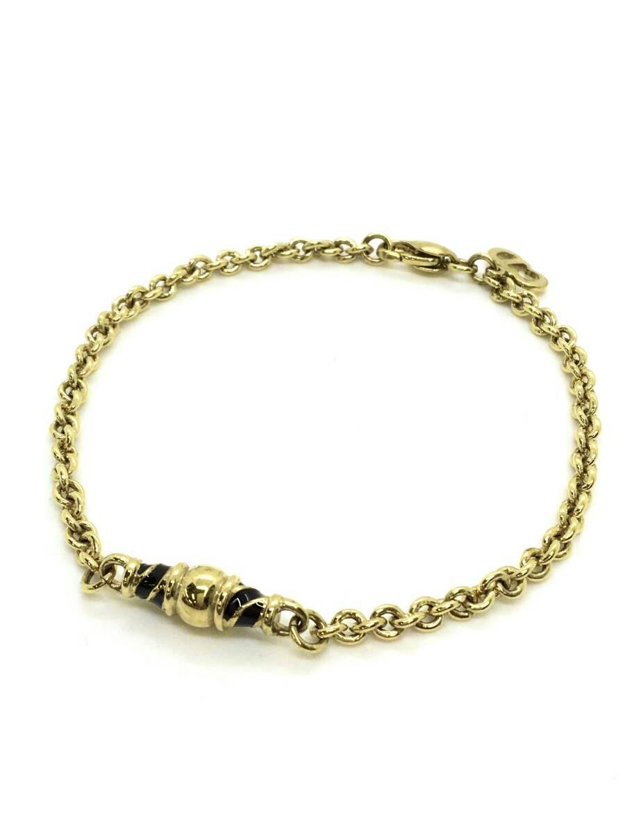 Gold-colored Christian Dior chain bracelet laid flat on a white background showing the chain, a central bead accent, and the clasp.