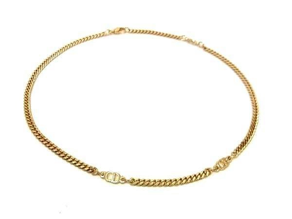 Gold-tone Christian Dior vintage necklace laid flat on a white background showing chain and CD logo accents.