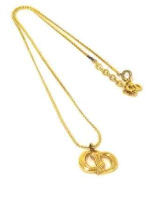 Gold-tone vintage Christian Dior women's necklace with an interlocking pendant on a thin chain.