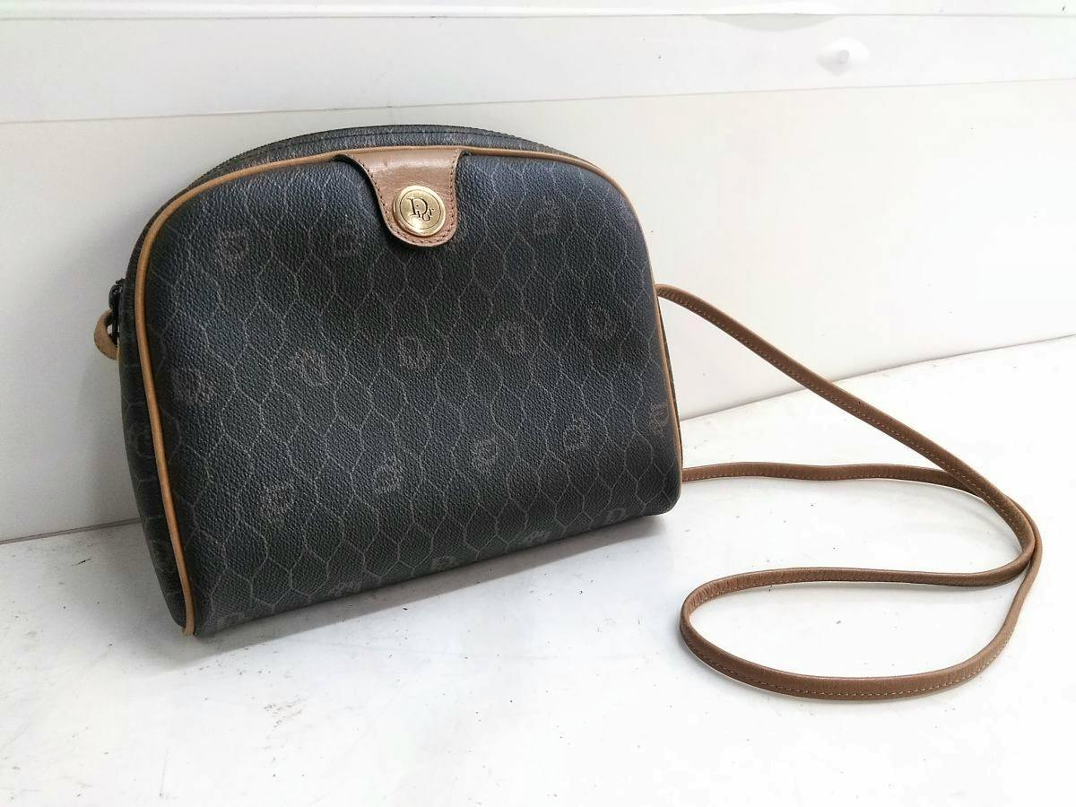 Front view of the Christian Dior vintage honeycomb-pattern shoulder pochette crossbody bag in dark synthetic leather with tan piping and strap.