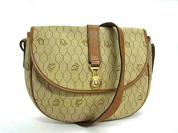 Front view of a beige and brown Christian Dior vintage honeycomb-pattern PVC and leather crossbody shoulder bag with flap and leather strap.