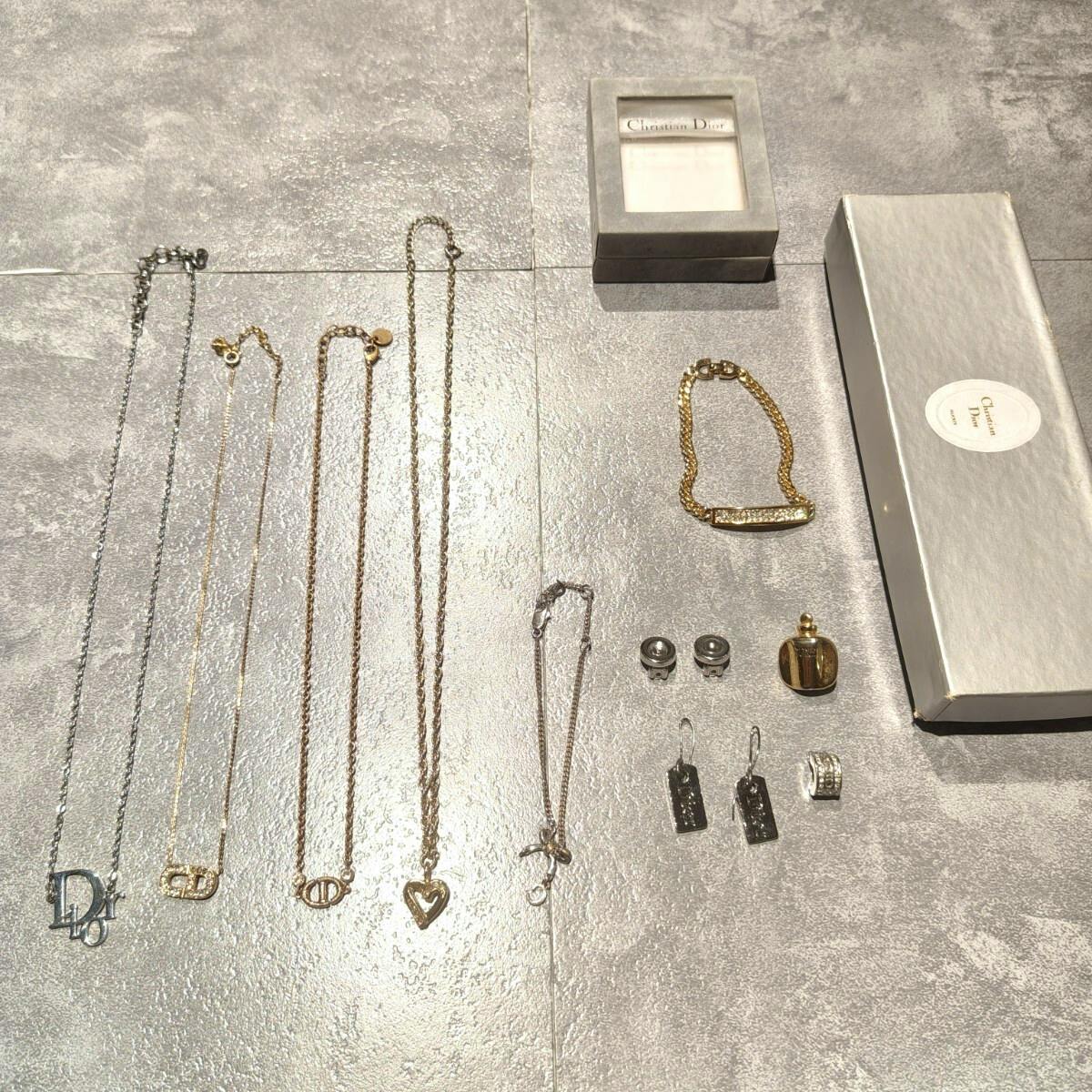 Several Christian Dior necklaces, a bracelet, earrings, and jewelry boxes arranged on a tabletop.