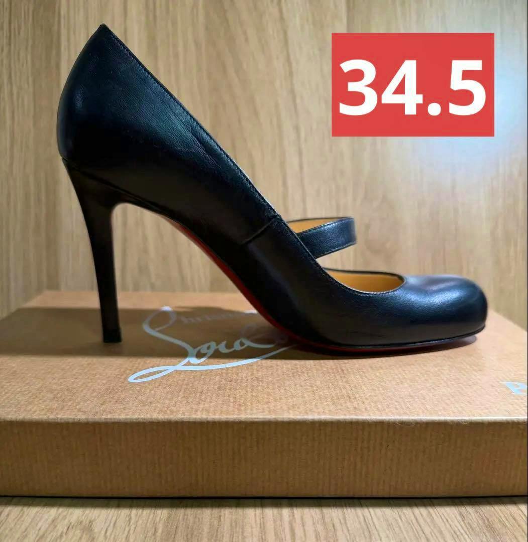 Black Wallis 85 pump (size 34.5) shown in side view on its shoebox, revealing the heel and red sole.
