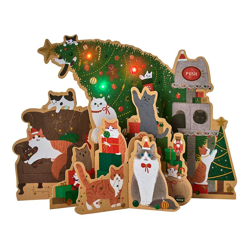 Fold-out Christmas greeting card featuring illustrated cats around a decorated tree with lit LED lights and a visible "PUSH" button.