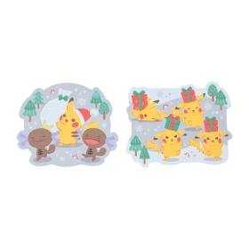Photo of two die-cut mini postcards featuring Pikachu in Christmas scenes with gifts and trees.