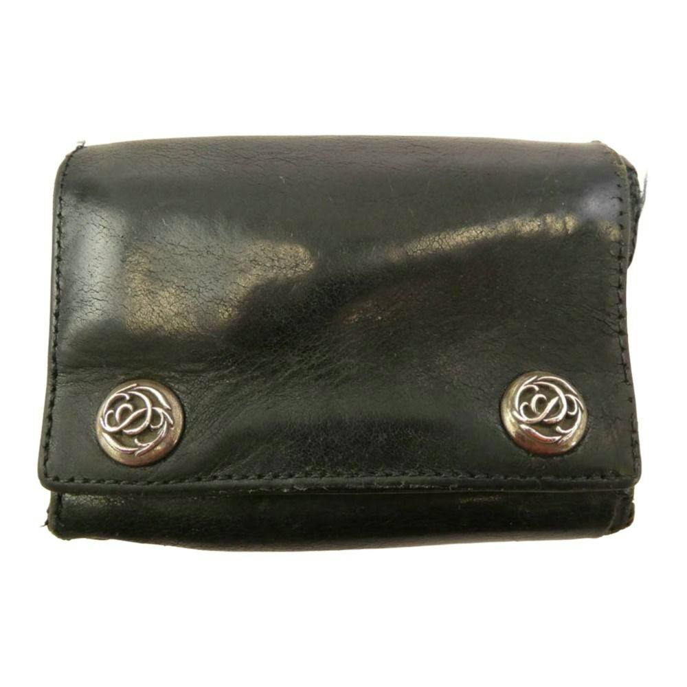 Black 3-fold cow leather wallet with two floral metal buttons visible on the front.