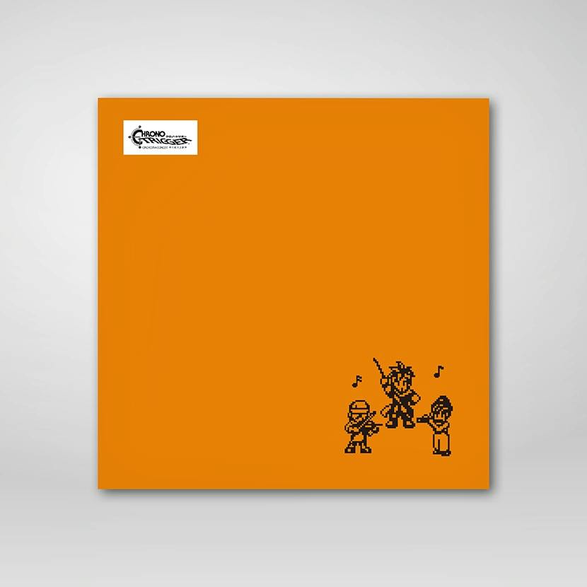Orange square hand towel with small pixel-art Chrono Trigger characters at the lower-right and a logo at the upper-left.
