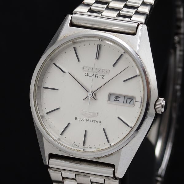 Close-up photo of a Citizen Seven Star silver-dial quartz day-date wristwatch with stainless steel bracelet.