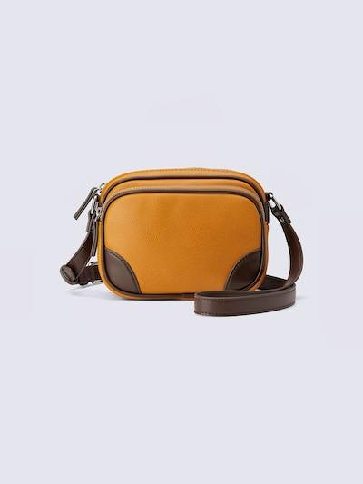 Yellow-orange mini shoulder bag with brown corner accents and a long brown strap on a plain light background.