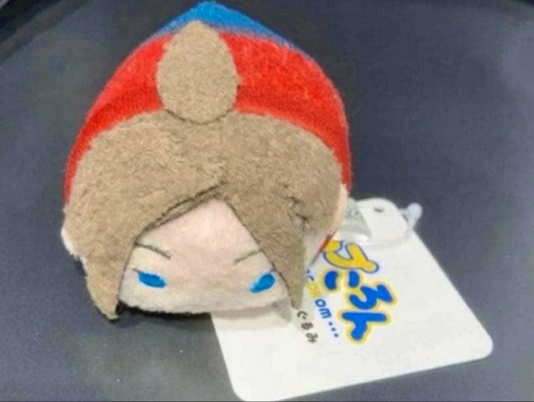 Small round Claire plush (Capcom Store Biohazard) resting on a dark surface with its tag visible.