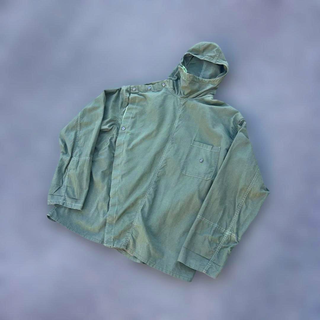 Green cotton men's French army SONORCO parka-style jacket with hood laid flat showing the front and chest pocket.