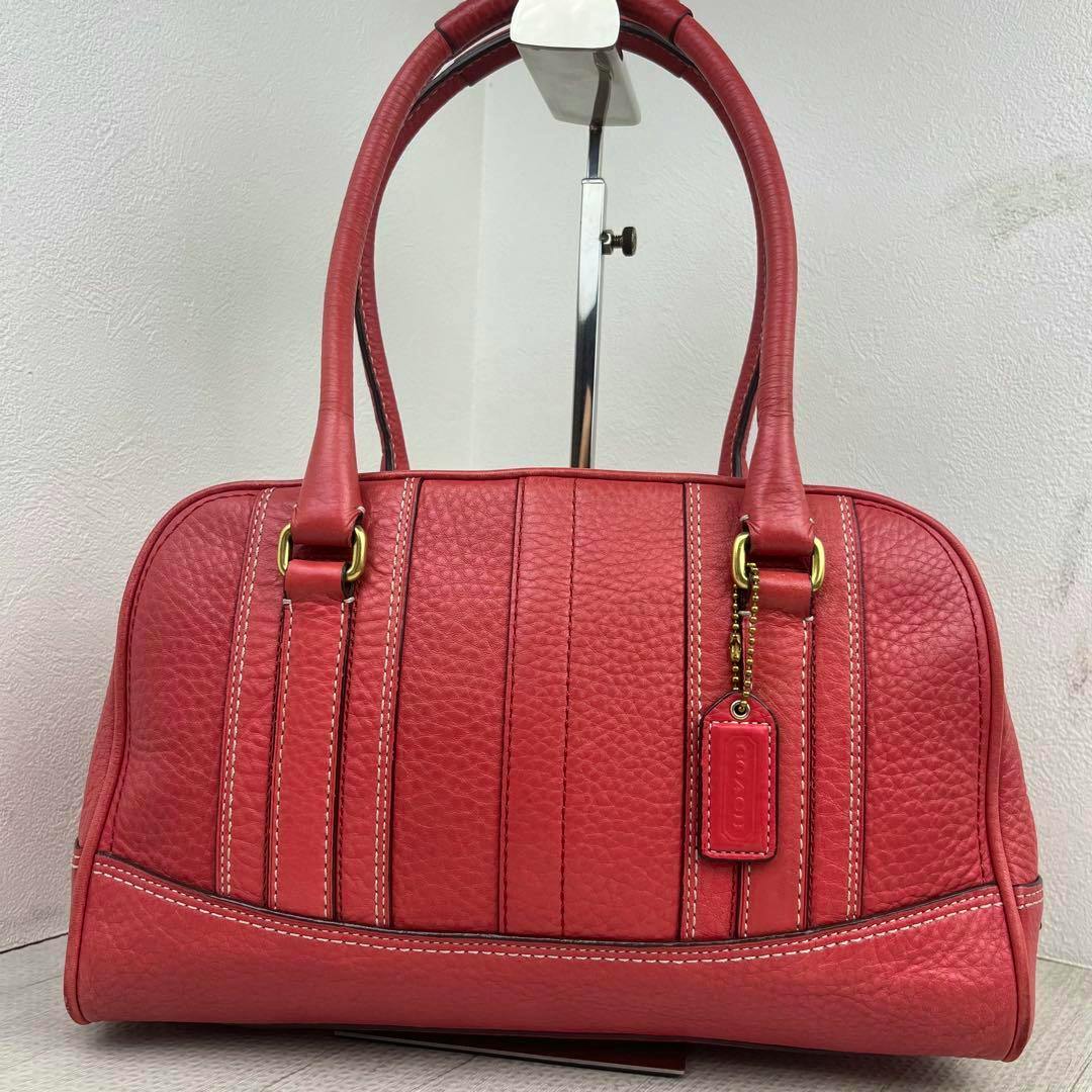 Front view of a red COACH 10526 handbag satchel tote bag with two handles and a hanging COACH tag.
