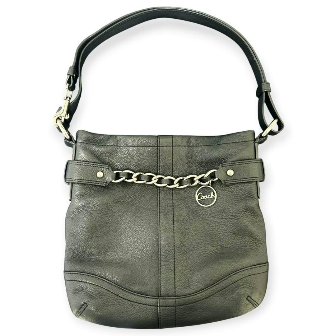 Front view of a black leather COACH shoulder bag with a chain detail and single strap.