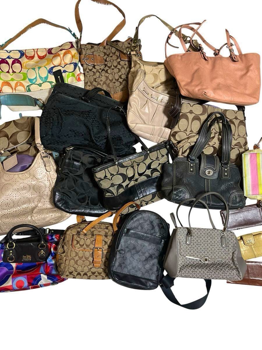 Assortment of Coach bags and wallets arranged together on a white background.