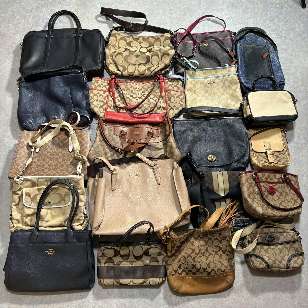 Overhead photo showing a collection of Coach bags and purses arranged together on a floor.