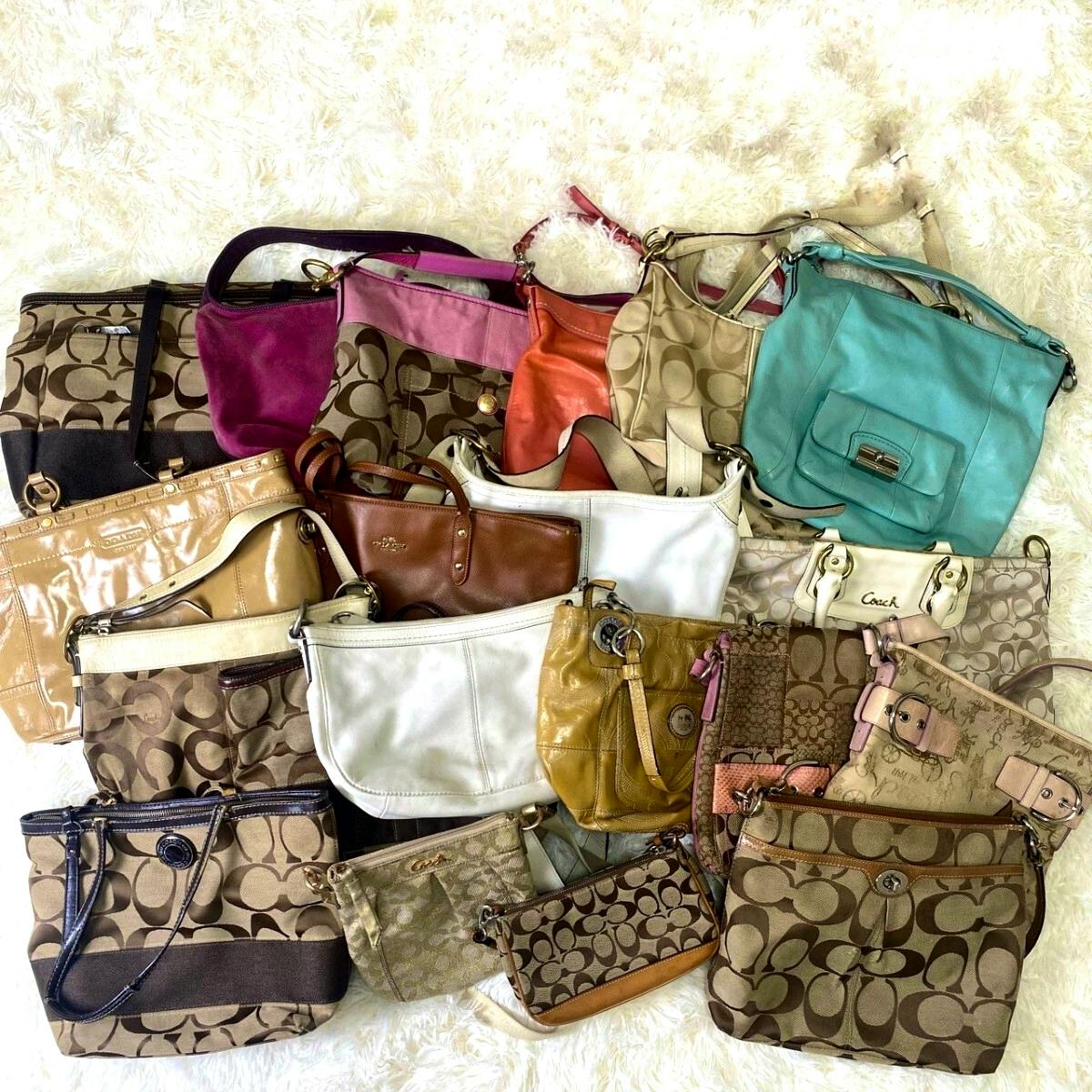 A collection of COACH handbags and pouches arranged on a light background showing various styles and colors.